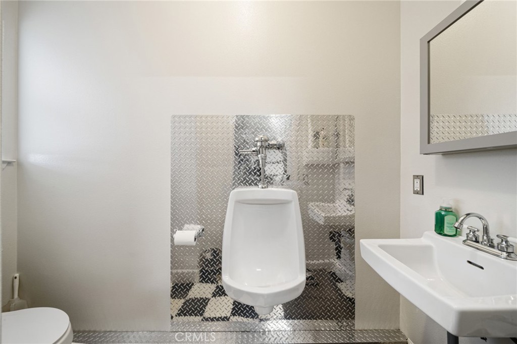 26487 Thacker Drive Hemet, CA 92544 - Photo 60 of 60 a bathroom with a toilet a sink and mirror