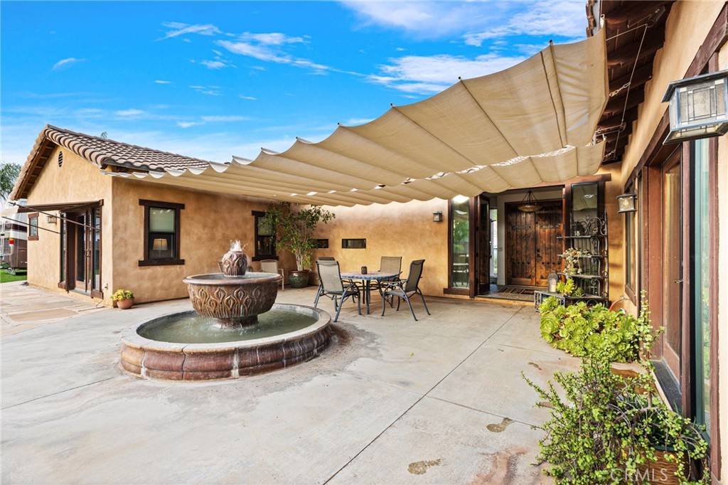 26487 Thacker Drive Hemet, CA 92544 - Photo 10 of 60 a view of a patio with table and chairs and potted plants