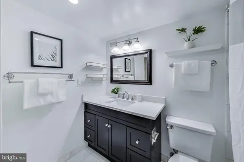 a bathroom with a sink vanity and a mirror
