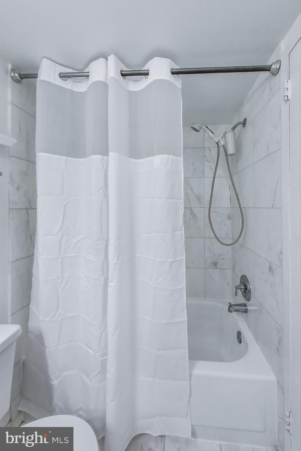 1325 18th Street Northwest, Unit 1009 Washington, DC 20036 - Photo 12 of 24 a bathroom with a glass shower door