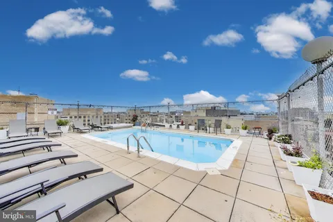 a view of a swimming pool with outdoor seating