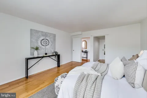 a bedroom with a bed and painting on the wall