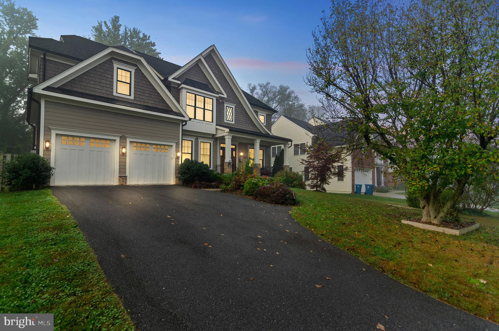 6801 Danforth Street McLean, VA 22101 - Photo 2 of 29 a view of a white house next to a yard with big trees