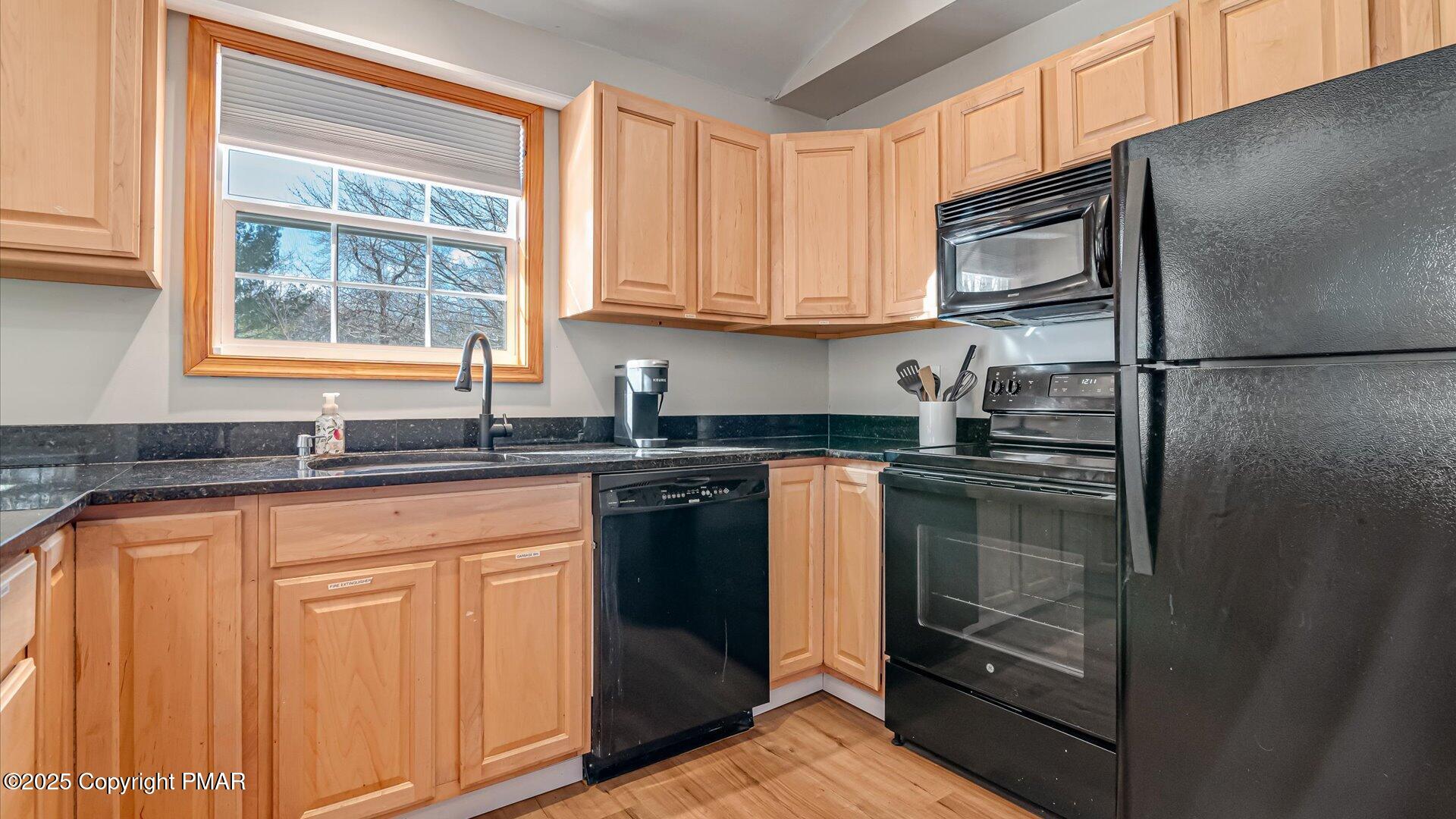 277 Fern Ridge Road Blakeslee, PA 18610 - Photo 11 of 46 a kitchen with stainless steel appliances granite countertop a refrigerator and a sink