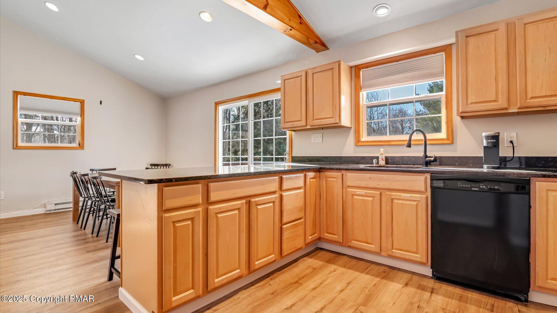 277 Fern Ridge Road Blakeslee, PA 18610 - Photo 12 of 46 a kitchen with stainless steel appliances granite countertop a stove a sink and a microwave