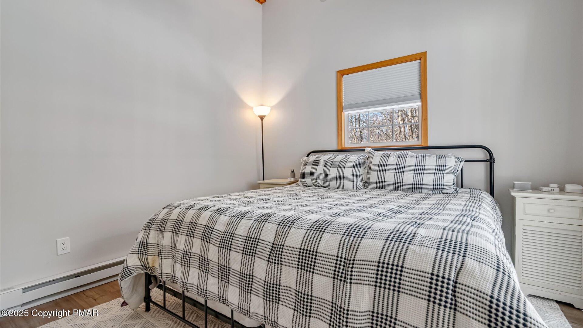 277 Fern Ridge Road Blakeslee, PA 18610 - Photo 14 of 46 a bedroom with a bed and lamp