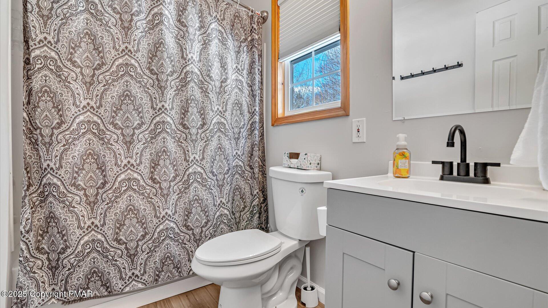 277 Fern Ridge Road Blakeslee, PA 18610 - Photo 16 of 46 a bathroom with a toilet sink and mirror