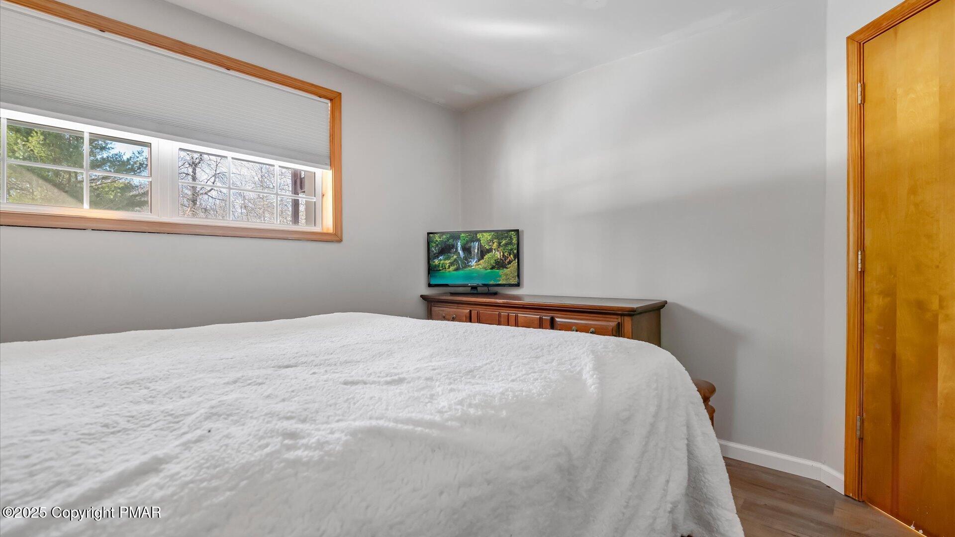 277 Fern Ridge Road Blakeslee, PA 18610 - Photo 23 of 46 a bedroom with a bed and wooden floor