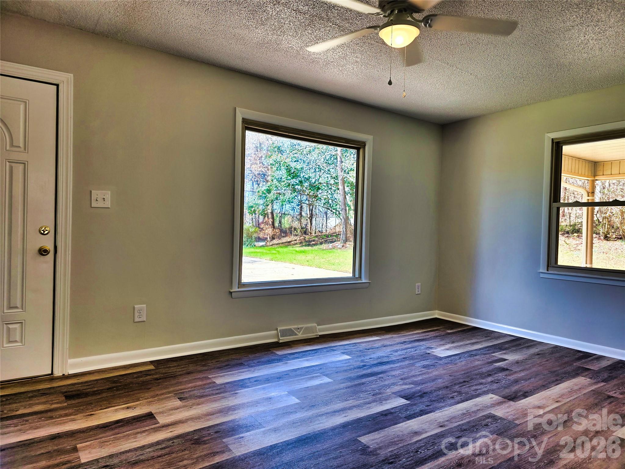 323 Mt Bethel Road Harmony, NC 28634 - Photo 11 of 25 wooden floor in an empty room with a window