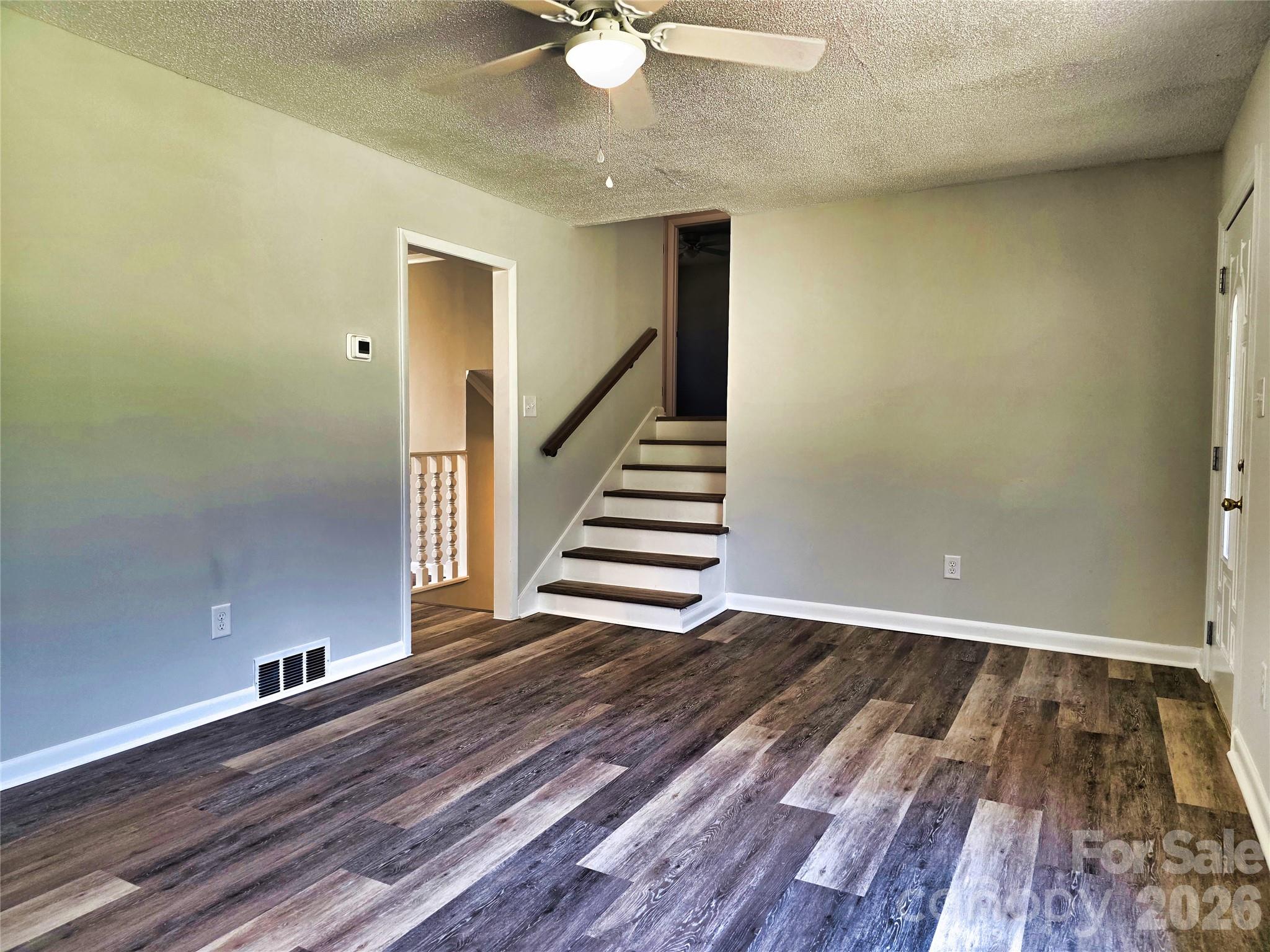 323 Mt Bethel Road Harmony, NC 28634 - Photo 12 of 25 wooden floor in an empty room with a chandelier