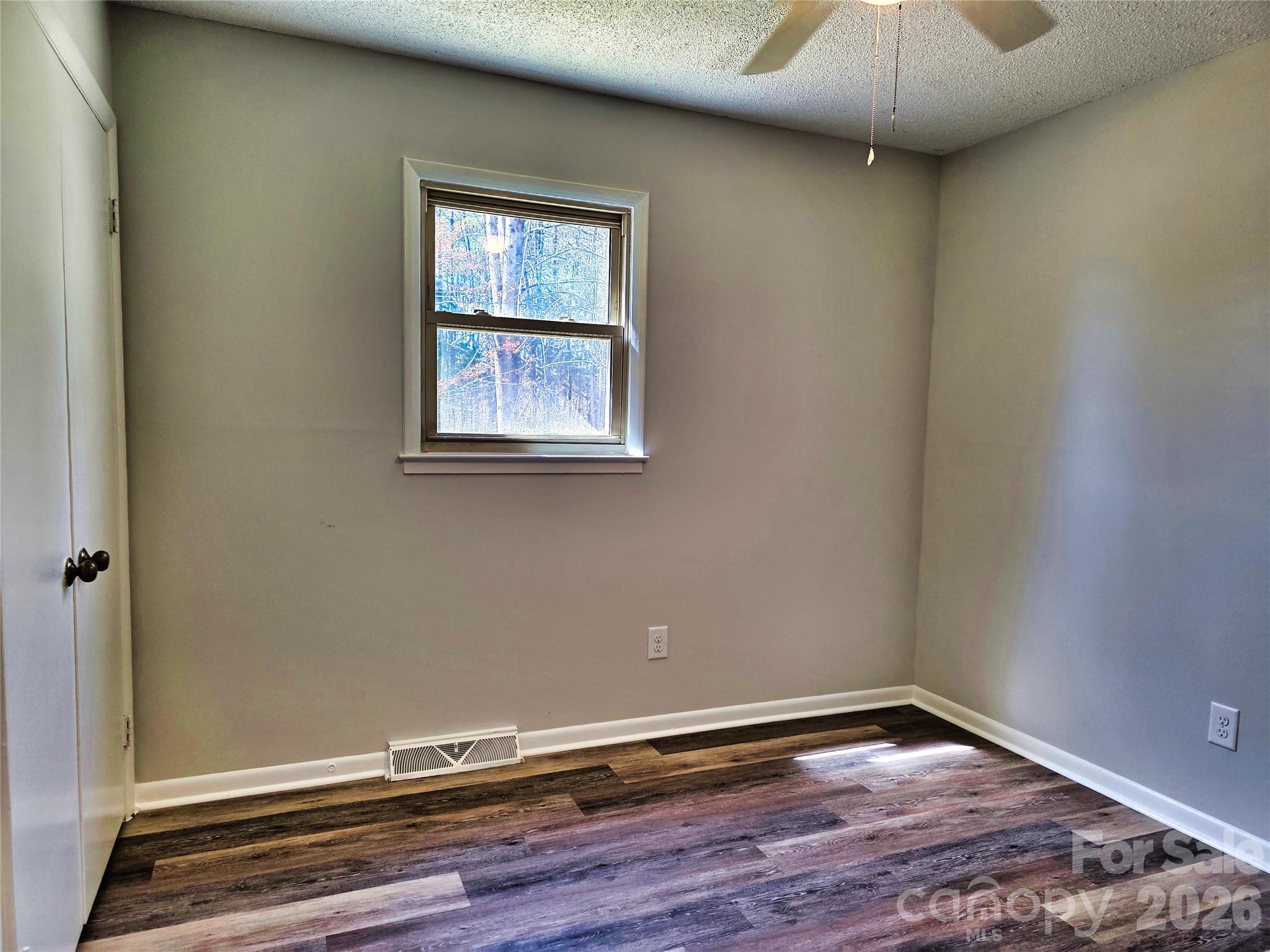323 Mt Bethel Road Harmony, NC 28634 - Photo 13 of 25 an empty room with wooden floor and windows
