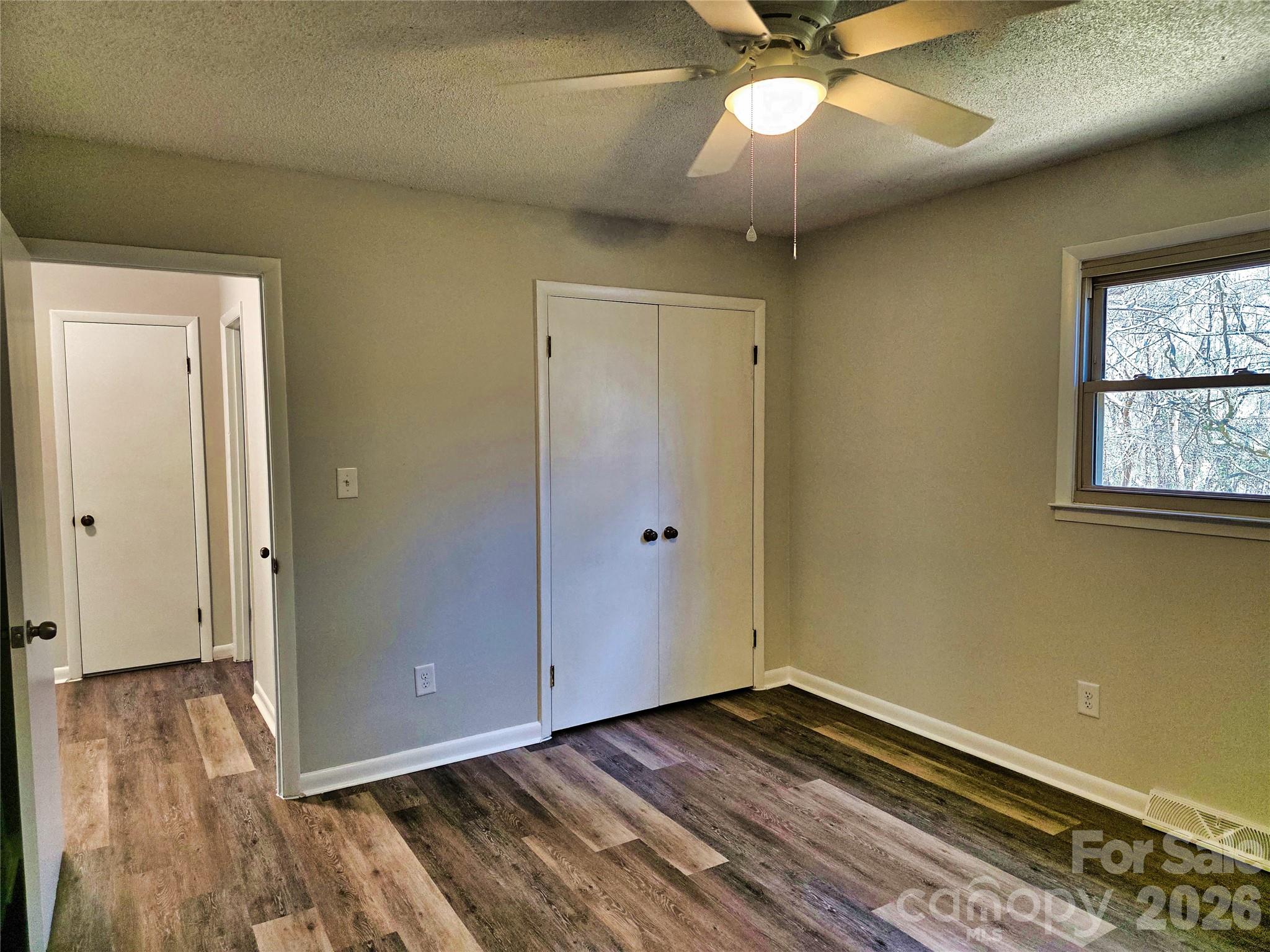 323 Mt Bethel Road Harmony, NC 28634 - Photo 17 of 25 a view of empty room with wooden floor and fan