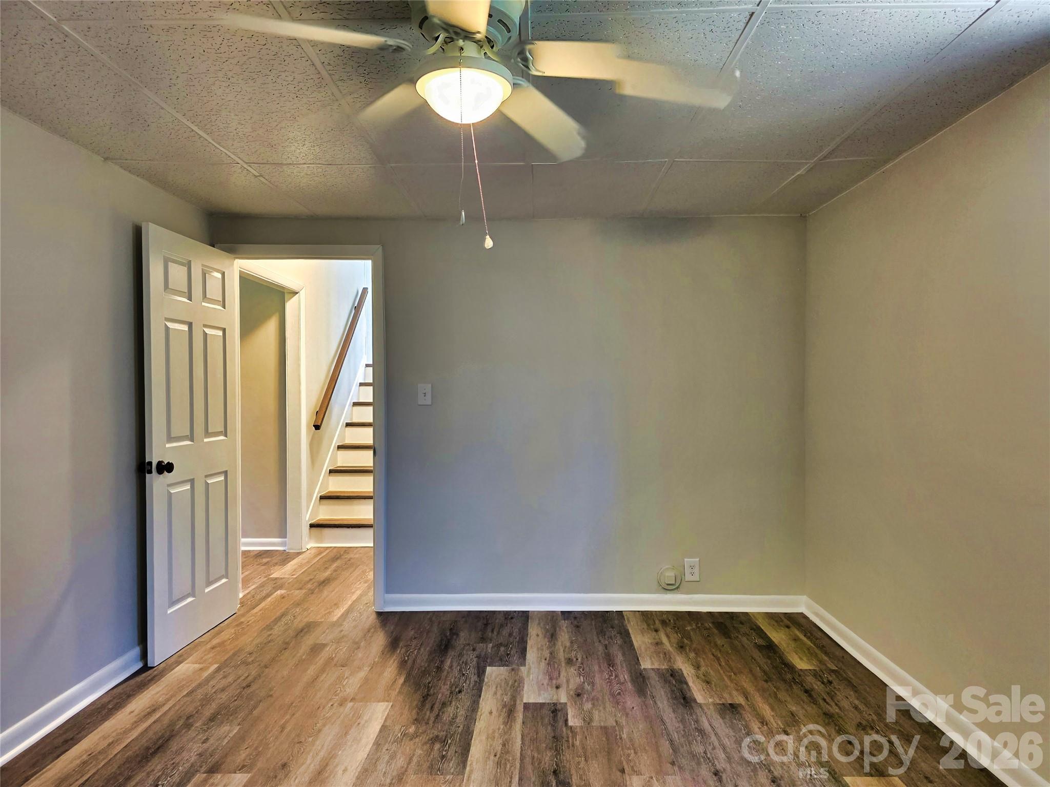 323 Mt Bethel Road Harmony, NC 28634 - Photo 22 of 25 an empty room with wooden floor chandelier fan and closet area