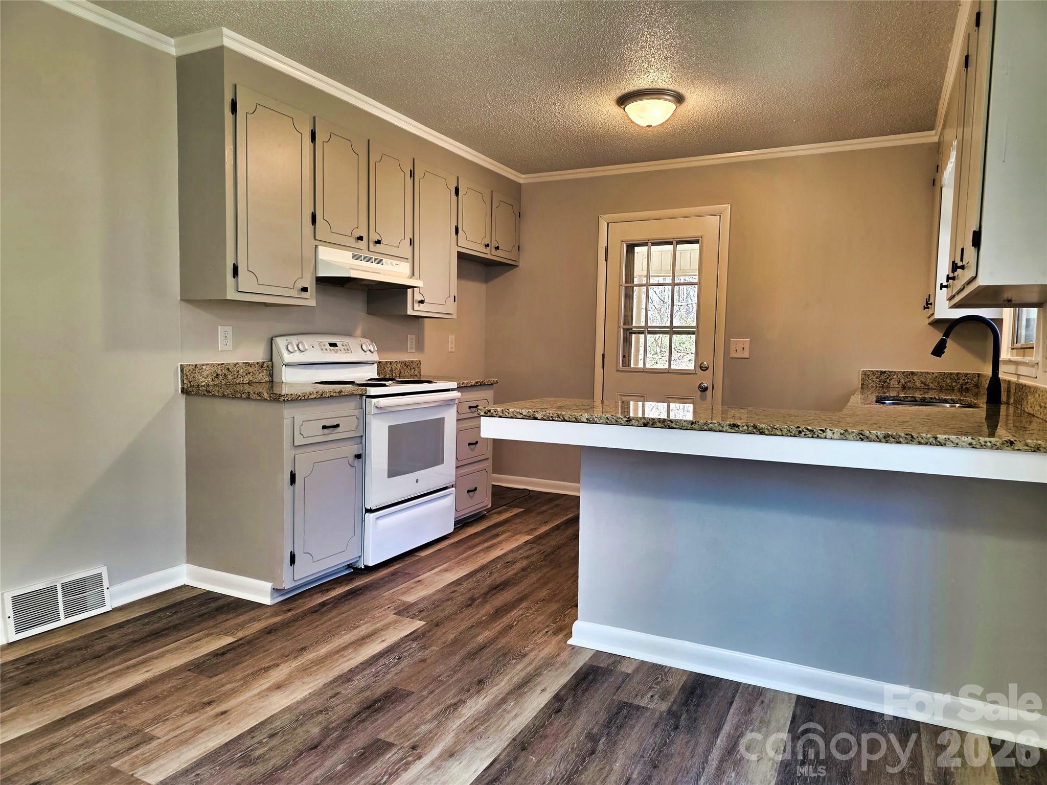 323 Mt Bethel Road Harmony, NC 28634 - Photo 10 of 25 a kitchen with stainless steel appliances a stove a sink and a microwave