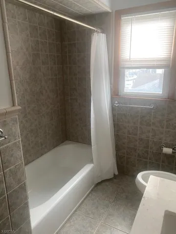 a bathroom with a shower and a bathtub
