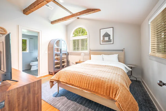 a bedroom with a bed and a table