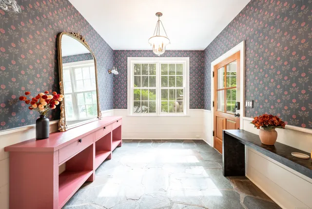 a very nice looking room with a large window and chandelier