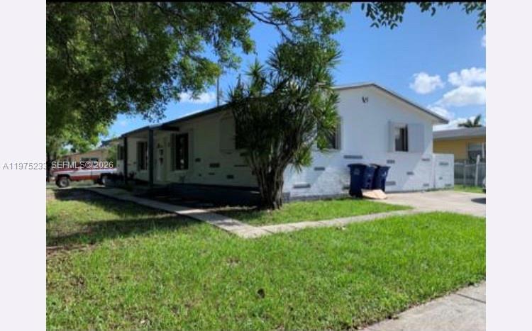 401 Southwest 8th Street, Unit A Hallandale Beach, FL 33009 - Photo 1 of 17 a view of back yard with outdoor seating