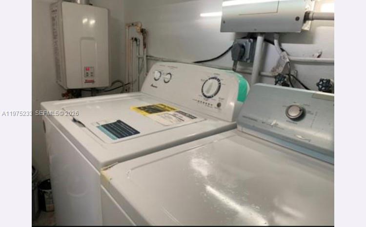 401 Southwest 8th Street, Unit A Hallandale Beach, FL 33009 - Photo 11 of 17 a utility room with dryer and washer