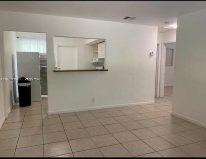401 Southwest 8th Street, Unit A Hallandale Beach, FL 33009 - Photo 14 of 17 a view of a refrigerator and cabinets