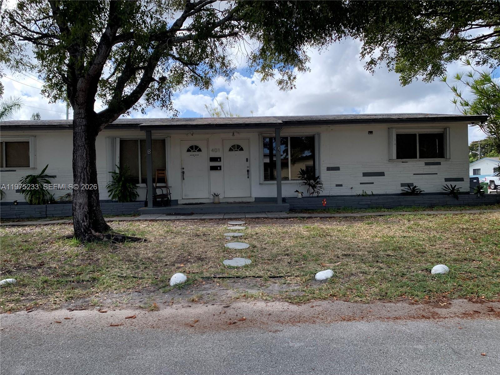 401 Southwest 8th Street, Unit A Hallandale Beach, FL 33009 - Photo 15 of 17 a front view of house with yard