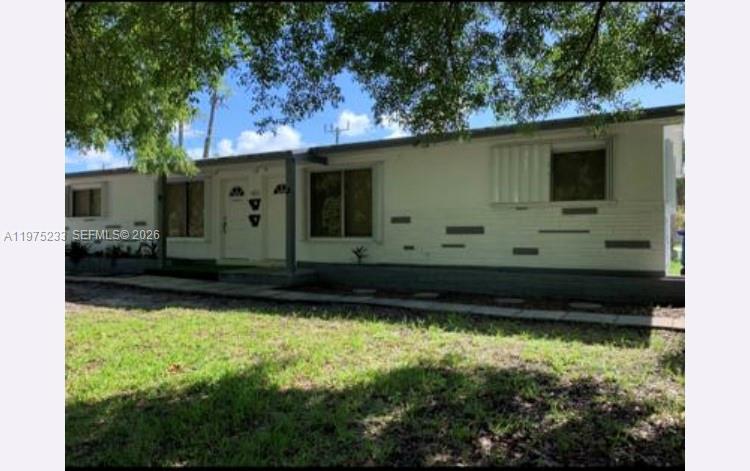 401 Southwest 8th Street, Unit A Hallandale Beach, FL 33009 - Photo 2 of 17 a view of a back yard of a house