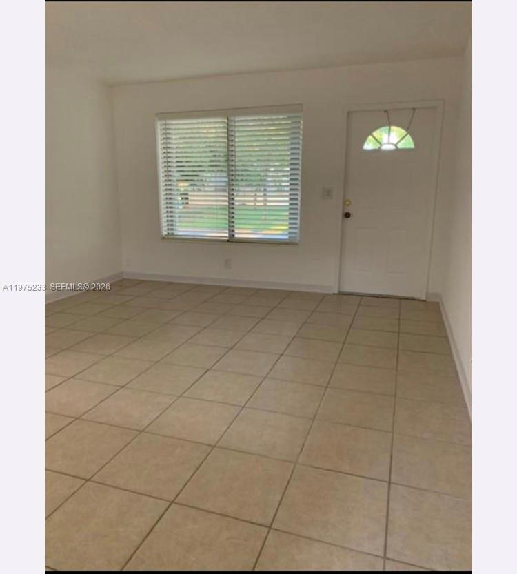401 Southwest 8th Street, Unit A Hallandale Beach, FL 33009 - Photo 3 of 17 a view of an empty room with a window