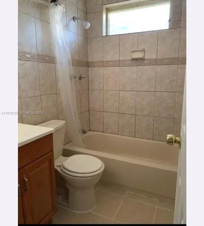 a bathroom with a toilet and shower