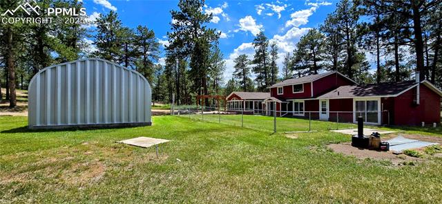 11785 Milam Road Colorado Springs, CO 80908 - Photo 11 of 44 View of yard featuring a shed