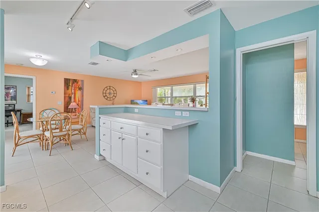 a spacious bathroom with a granite countertop sink a mirror and a vanity