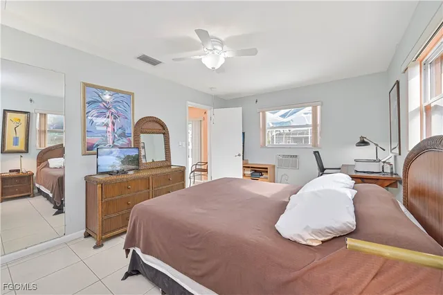 a bedroom with a large bed and window