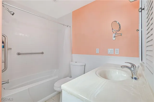 a bathroom with a sink vanity mirror and toilet