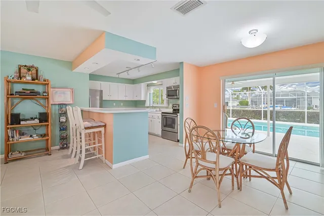 a dining room with furniture and a floor to ceiling window