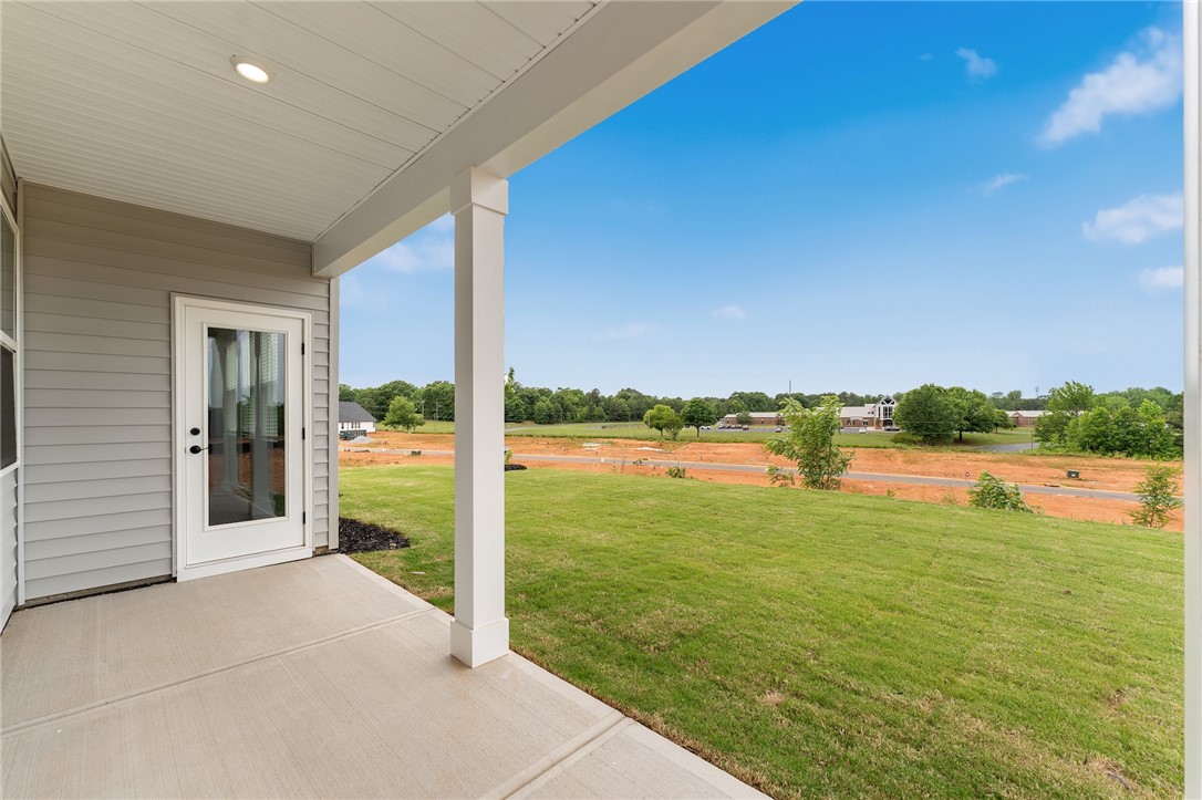 310 Bluestem Court Anderson, SC 29621 - Photo 34 of 36 Enjoy fresh air and views from this inviting covered patio, perfect for outdoor relaxation.