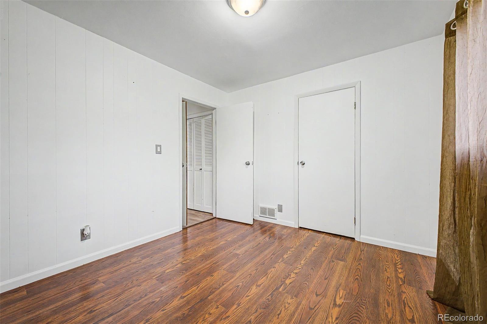145 Bailey Drive Bailey, CO 80421 - Photo 24 of 31 a view of an empty room with wooden floor