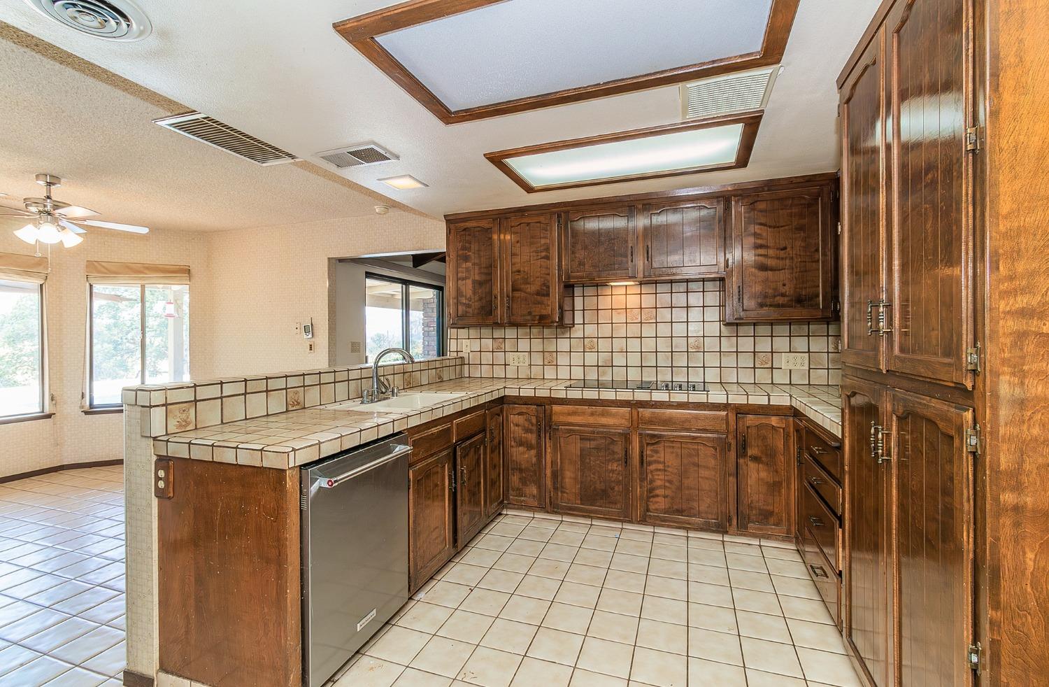10574 Millerton Road Clovis, CA 93619 - Photo 11 of 36 a kitchen with a sink stove and cabinets