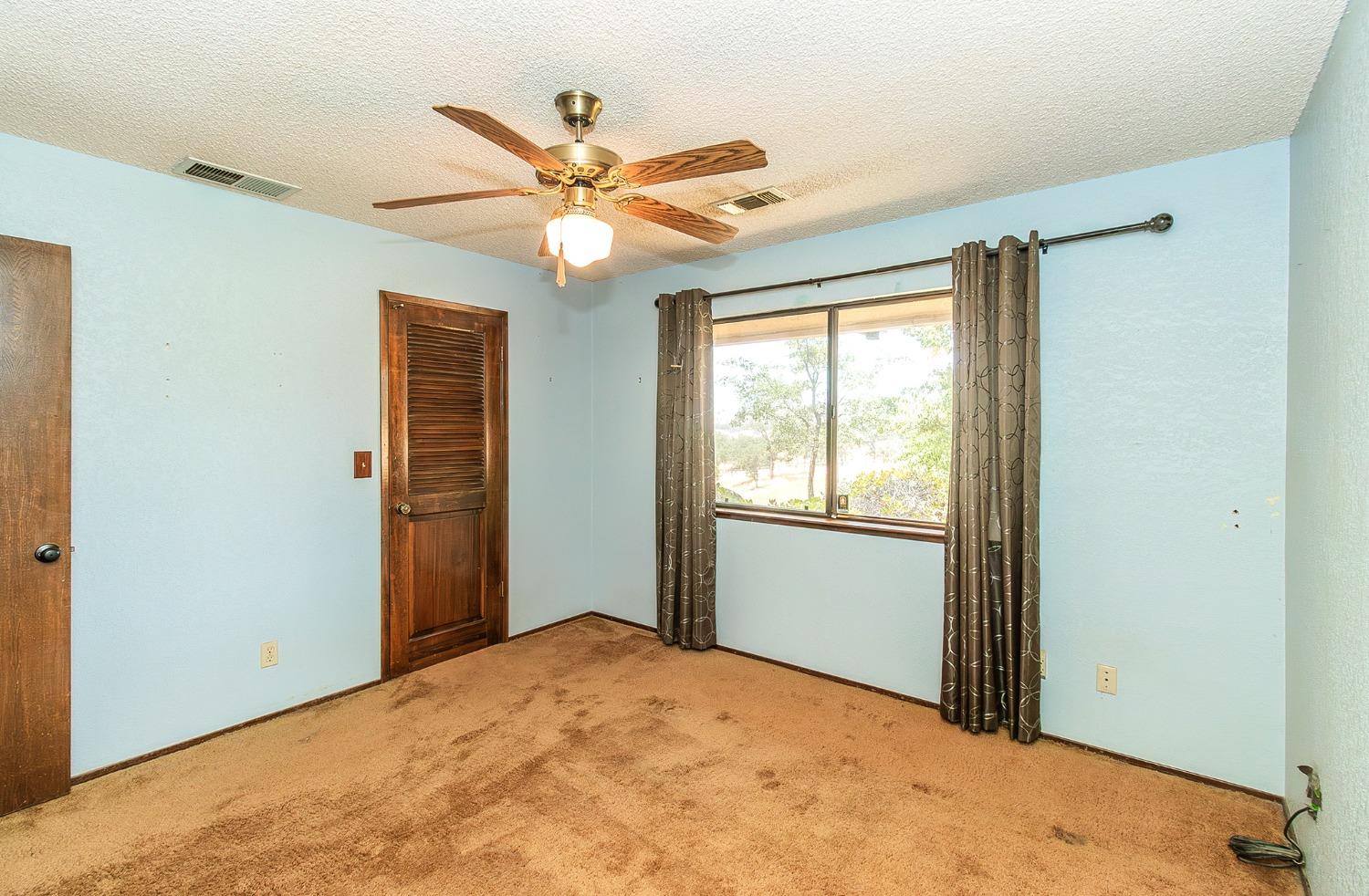 10574 Millerton Road Clovis, CA 93619 - Photo 17 of 36 a view of a livingroom with a ceiling fan and window