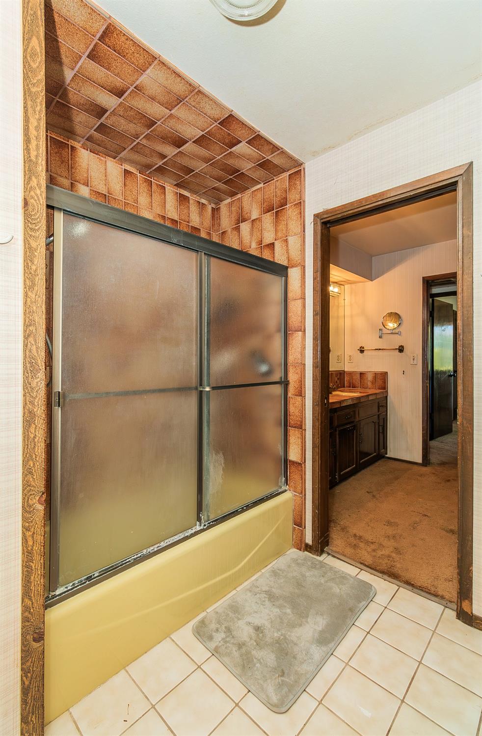 10574 Millerton Road Clovis, CA 93619 - Photo 21 of 36 a view of a bathroom with a sink and a mirror