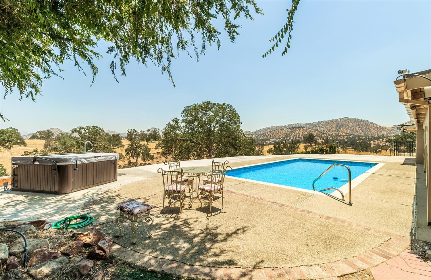 10574 Millerton Road Clovis, CA 93619 - Photo 24 of 36 a view of a swimming pool with an outdoor seating