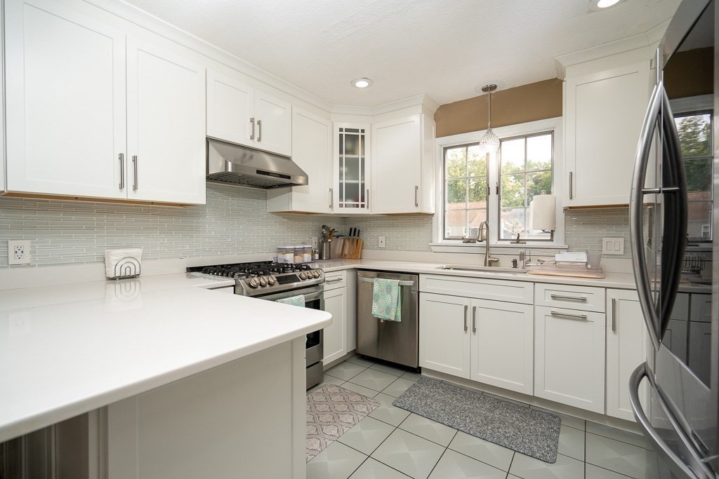 131 Clement Street Springfield, MA 01118 - Photo 4 of 32 a kitchen with a sink stove and refrigerator