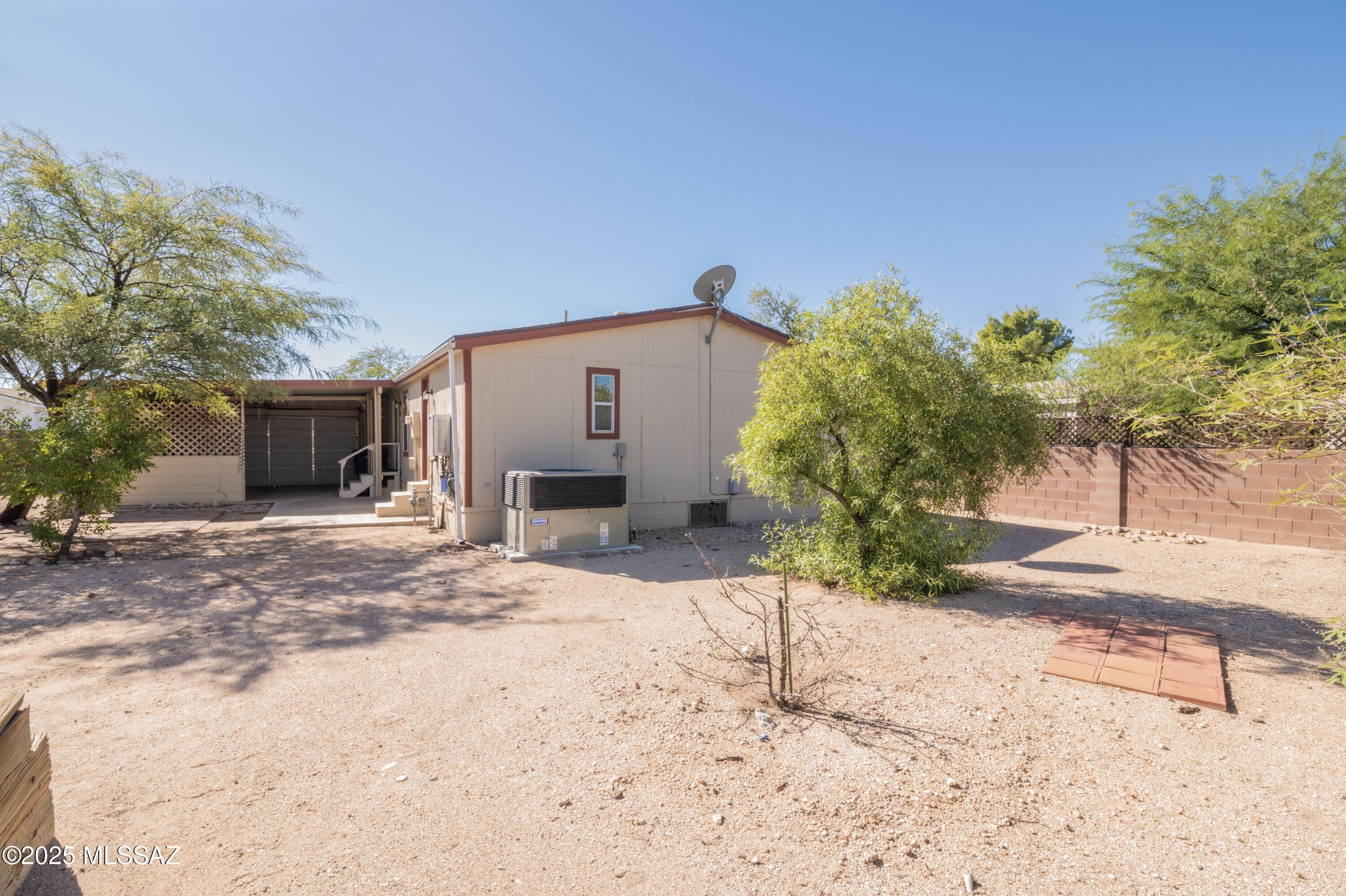 6205 East Rough Rock Drive Tucson, AZ 85756 - Photo 23 of 30 a front view of a house with a yard and garage