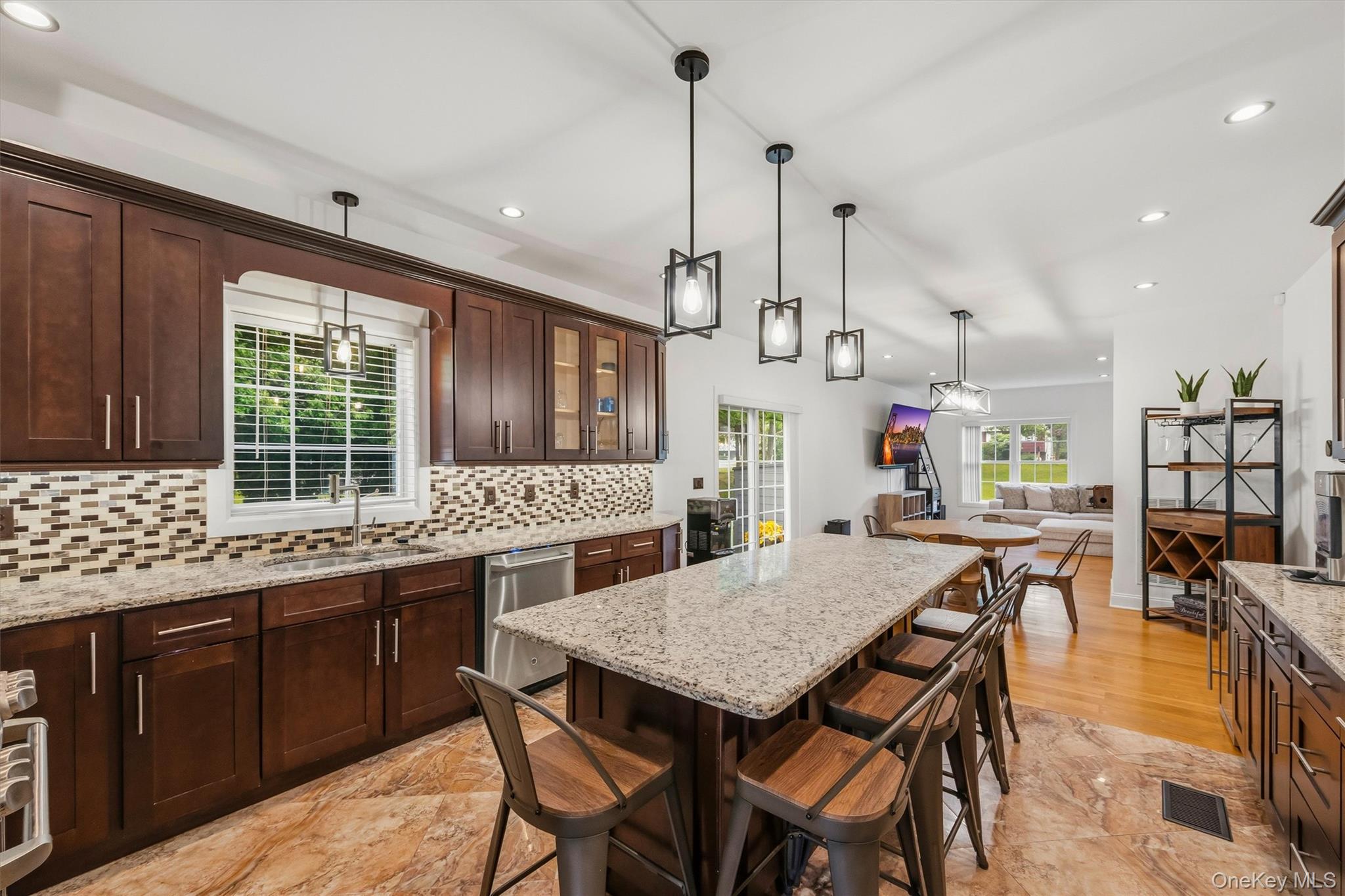 8 Darmstadter Road Bloomingburg, NY 12721 - Photo 19 of 47 Kitchen with 7 foot 7 inch center island that seats 6, Anderson casement window above sink, Cafe appliances, granite countertops, tile backsplash, uplighting, Recessed lighting, marble tile floors and 9 foot ceilings.