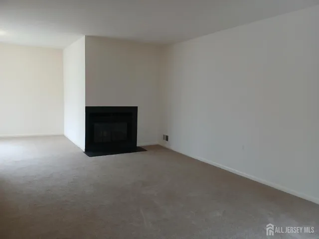 a view of an empty room with a fireplace