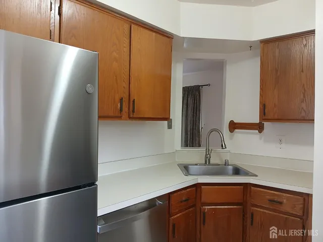 a kitchen with stainless steel appliances a refrigerator and a sink