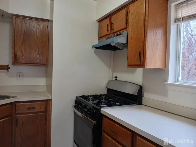 a kitchen with stainless steel appliances a stove and a microwave