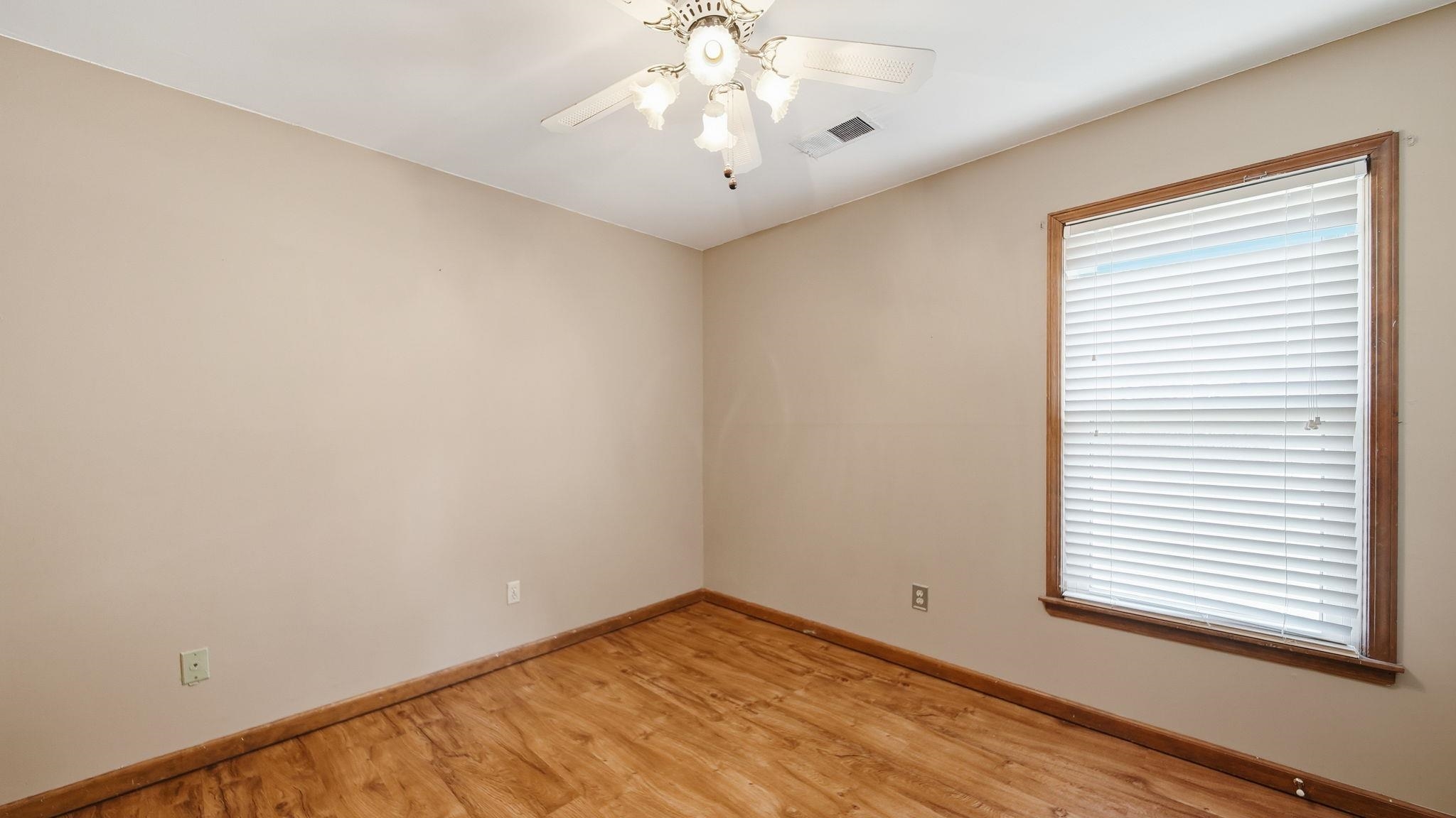 5069 Ross Road Memphis, TN 38141 - Photo 12 of 40 Unfurnished room with light wood-style flooring and ceiling fan