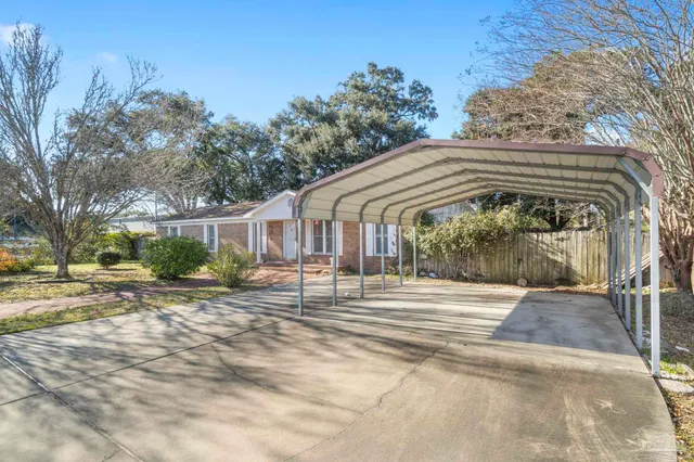 a patio with a table and chairs under an umbrella