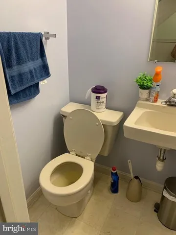 a white toilet sitting next to a bathroom sink