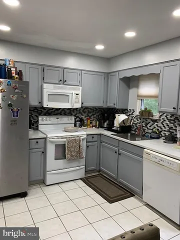 a kitchen with a stove a sink and a refrigerator