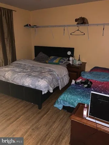 a bedroom with bed and a night stand